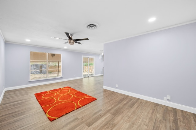 spare room featuring light hardwood / wood-style floors, ceiling fan, and crown molding