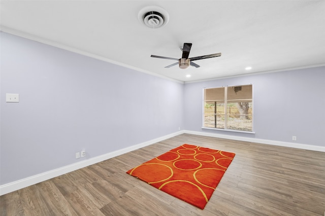 unfurnished room with wood-type flooring, crown molding, and ceiling fan