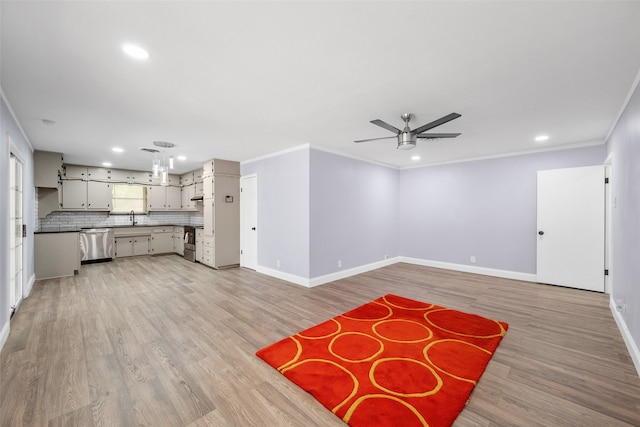 unfurnished living room with light wood-type flooring, ceiling fan, sink, and crown molding