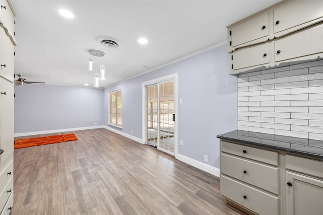 empty room featuring light hardwood / wood-style flooring, ceiling fan, and crown molding