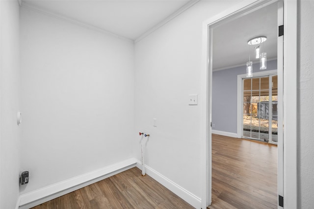 washroom featuring wood-type flooring, crown molding, and washer hookup