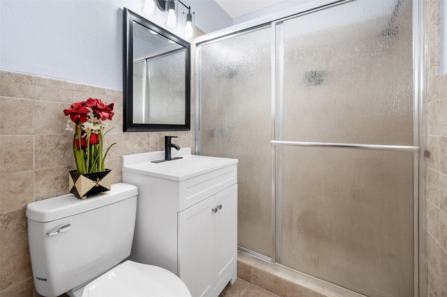 bathroom featuring tile walls, an enclosed shower, tile patterned floors, vanity, and toilet