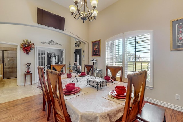 dining space with light wood-type flooring and a chandelier