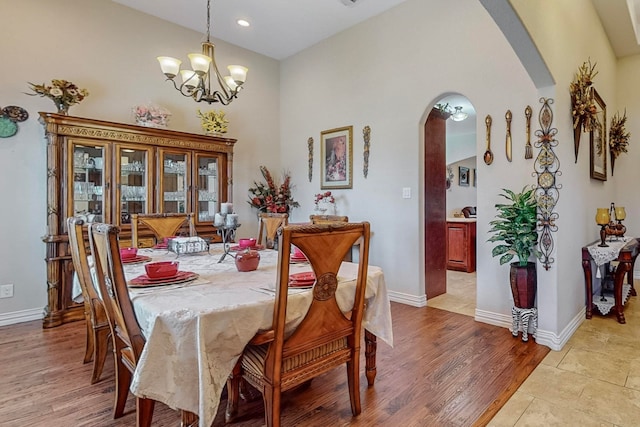 dining space with a notable chandelier and light wood-type flooring