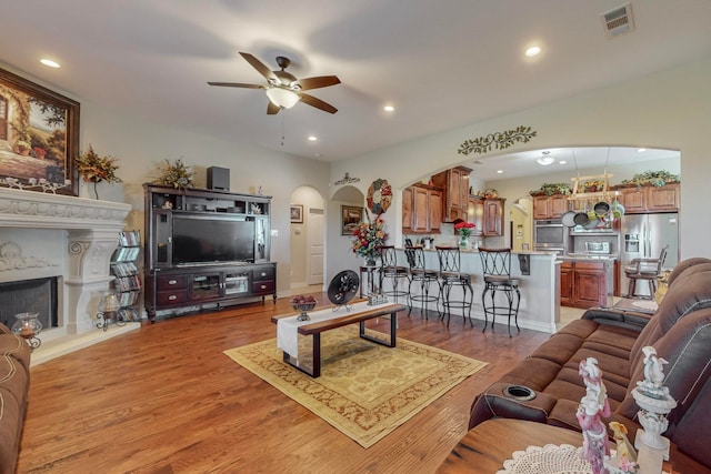 living room with ceiling fan and light hardwood / wood-style flooring