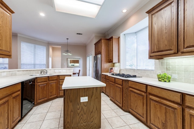 kitchen with light tile patterned flooring, sink, decorative backsplash, appliances with stainless steel finishes, and decorative light fixtures