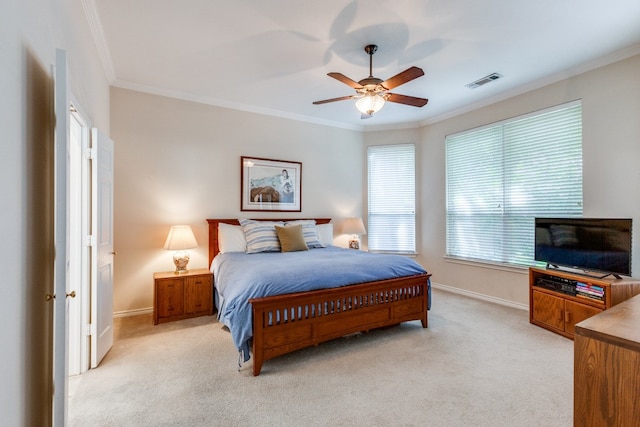 bedroom with light carpet, ceiling fan, and crown molding