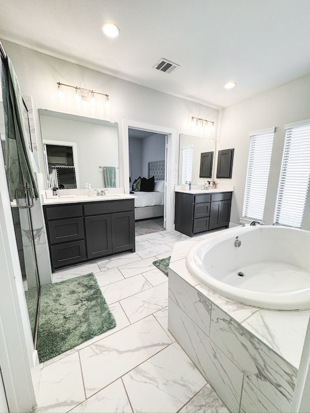 bathroom with vanity and independent shower and bath