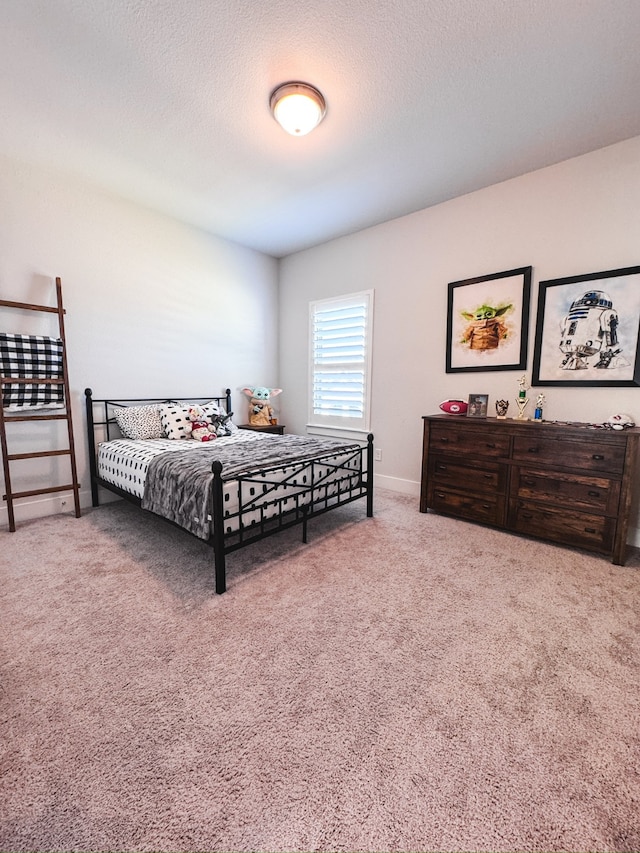 carpeted bedroom featuring a textured ceiling