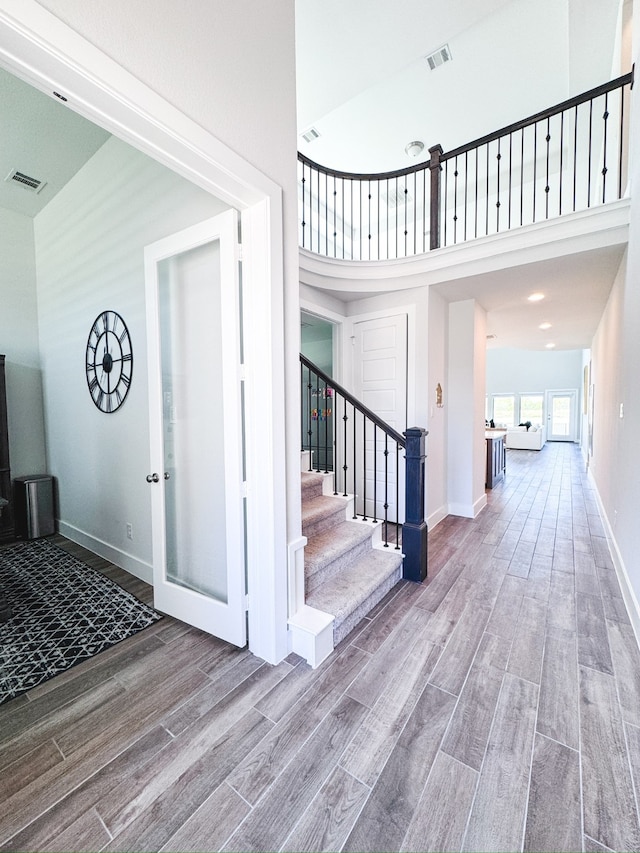 entrance foyer with a high ceiling and hardwood / wood-style flooring