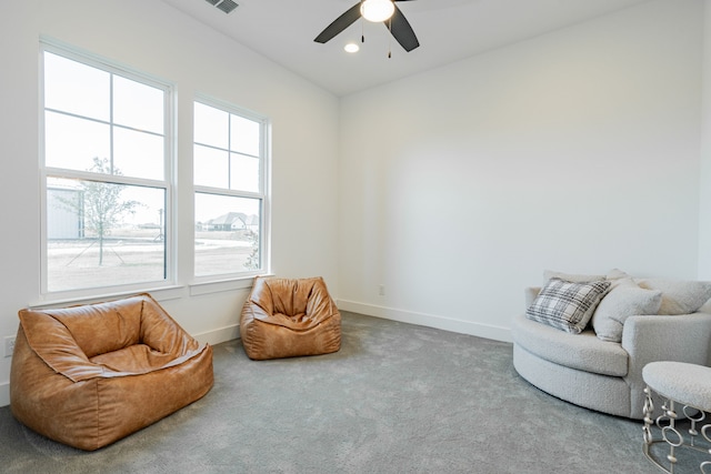 sitting room featuring carpet and ceiling fan