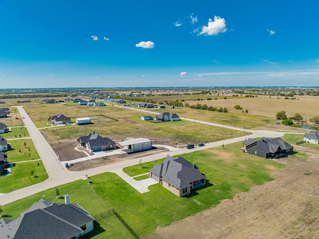 birds eye view of property with a rural view