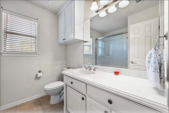 bathroom featuring vanity, tile patterned flooring, toilet, and an enclosed shower