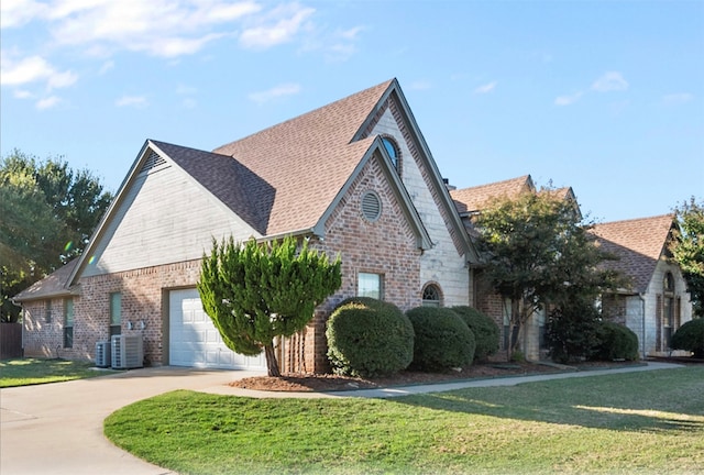 view of front of property with a garage and a front lawn