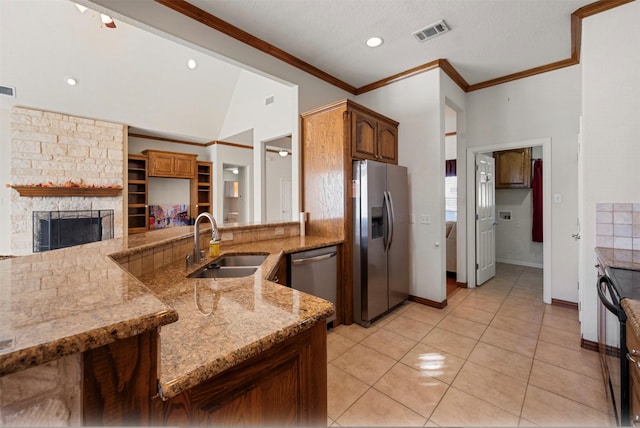 kitchen with light tile patterned floors, ornamental molding, stainless steel appliances, and sink