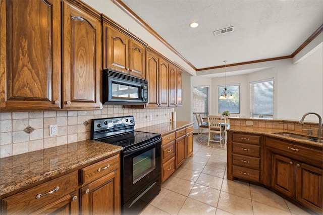 kitchen featuring sink, hanging light fixtures, decorative backsplash, black appliances, and light tile patterned floors