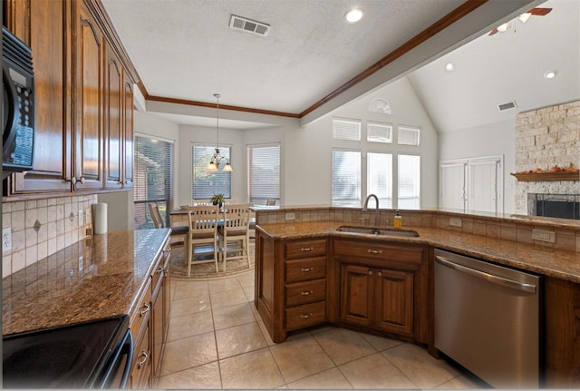 kitchen with decorative backsplash, a fireplace, a textured ceiling, black appliances, and sink