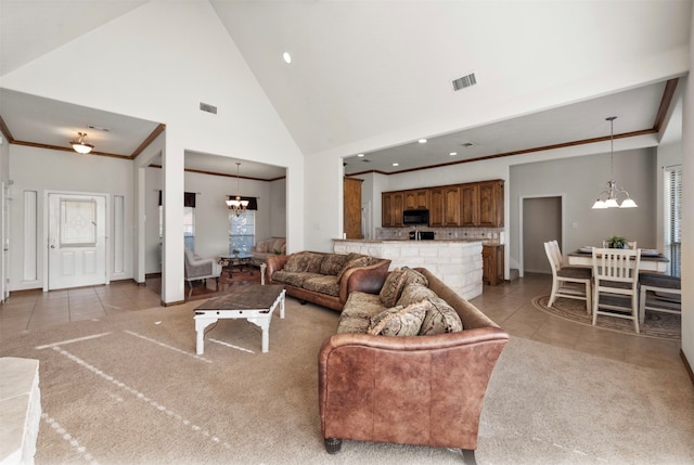 tiled living room with ornamental molding, a chandelier, and high vaulted ceiling