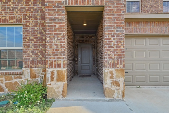 doorway to property with a garage