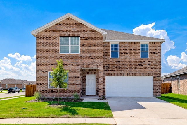 view of property with a garage and a front yard