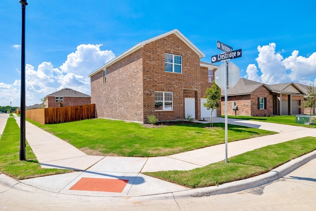 view of front of property with a front yard and a garage