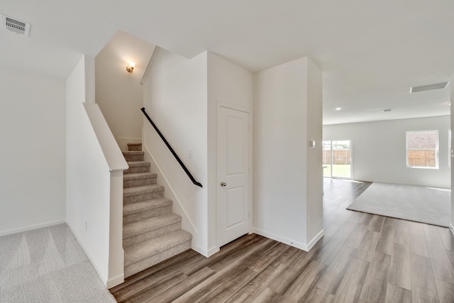 stairs featuring hardwood / wood-style flooring