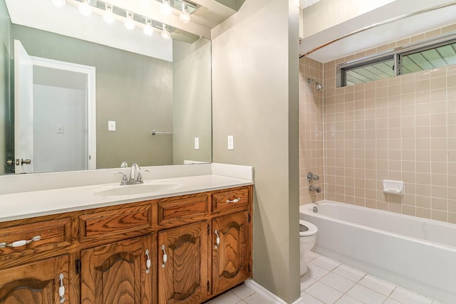 full bathroom with vanity, tiled shower / bath combo, toilet, and tile patterned flooring