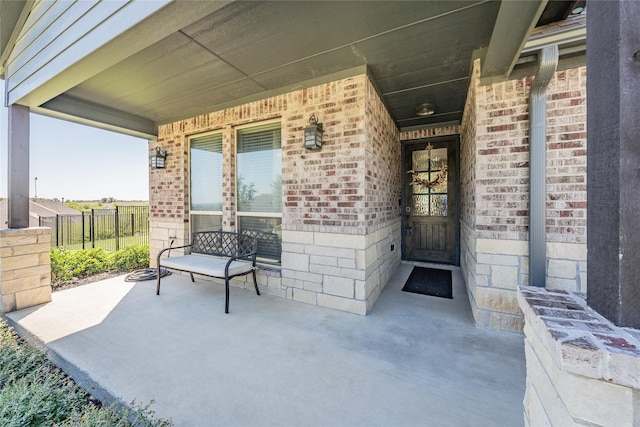 view of patio / terrace with a porch and fence