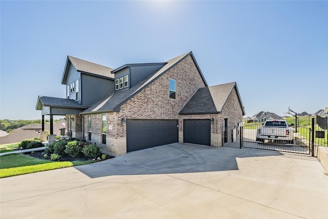 view of home's exterior with a gate, concrete driveway, fence, brick siding, and a garage