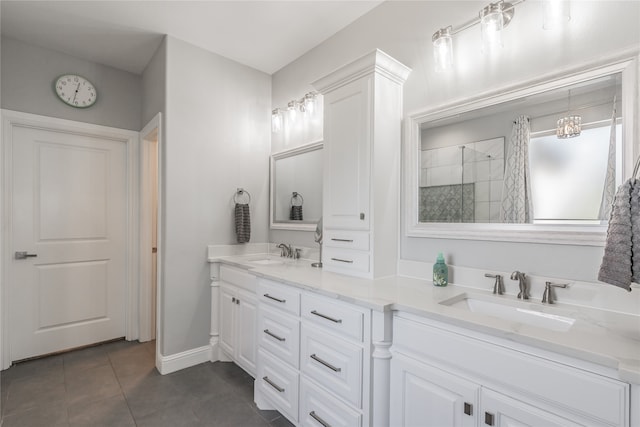 bathroom with an enclosed shower, vanity, and tile patterned floors