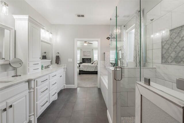 bathroom featuring ceiling fan, vanity, tile patterned floors, and tiled shower