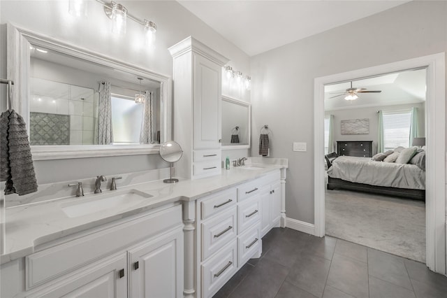 full bathroom featuring double vanity, ceiling fan, ensuite bathroom, and a sink