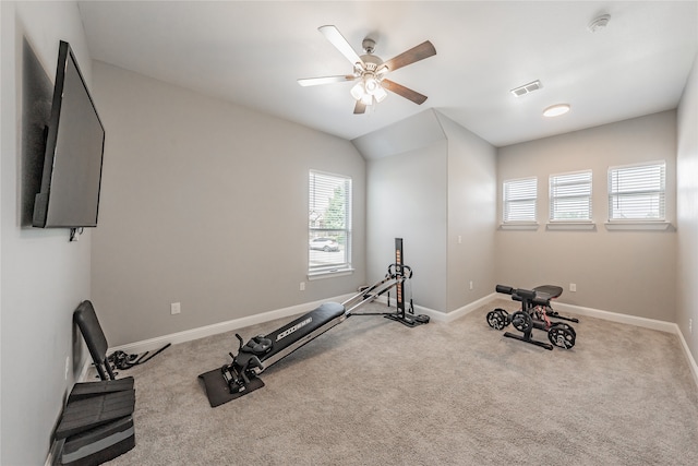 workout room with ceiling fan, light colored carpet, and lofted ceiling