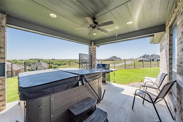 view of patio / terrace with fence, ceiling fan, a hot tub, and area for grilling