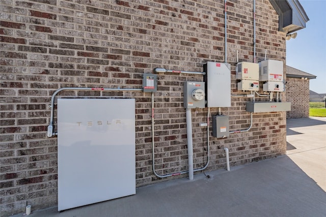 exterior details featuring brick siding and electric meter