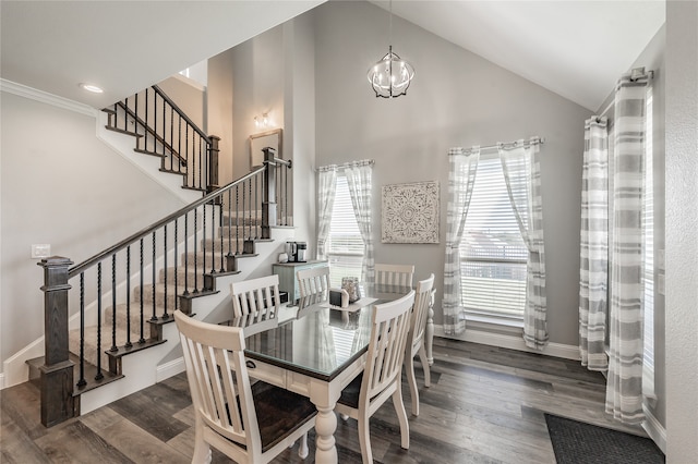 dining room with high vaulted ceiling, dark wood-type flooring, and a notable chandelier