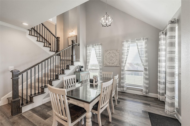 dining room featuring stairway, wood finished floors, baseboards, high vaulted ceiling, and a notable chandelier