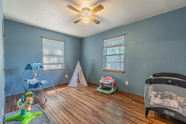 rec room with hardwood / wood-style flooring and ceiling fan