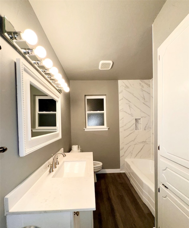 full bathroom with hardwood / wood-style floors, vanity, toilet, and independent shower and bath