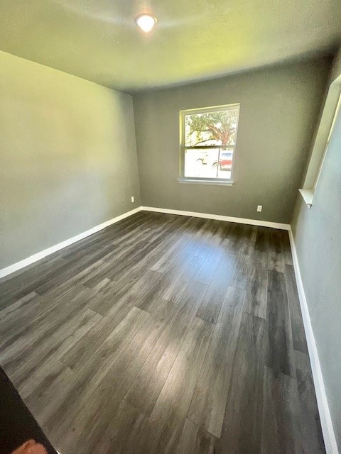 spare room with dark hardwood / wood-style flooring