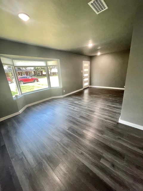 spare room featuring dark wood-type flooring