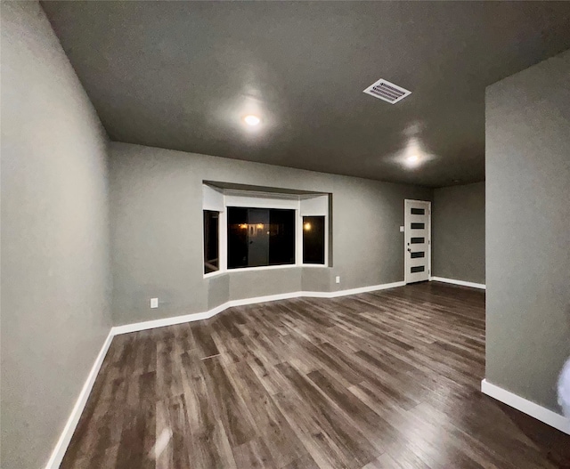 unfurnished room with wood-type flooring