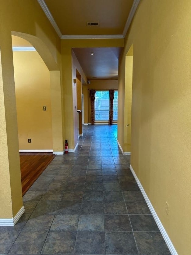 corridor featuring ornamental molding and dark hardwood / wood-style flooring