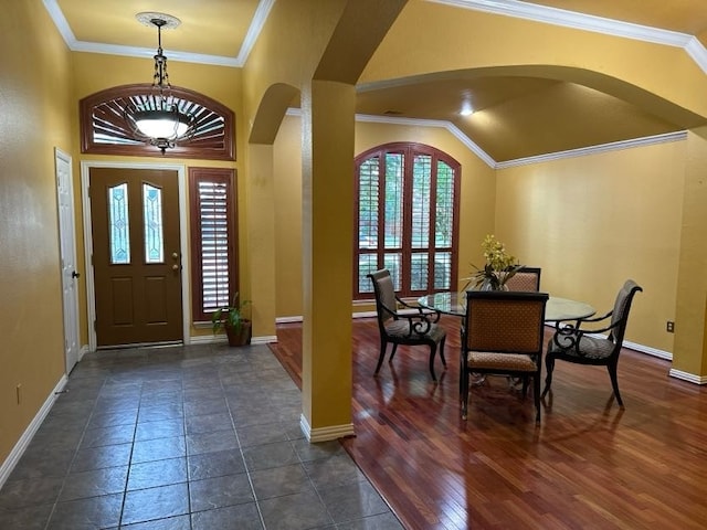 foyer with dark hardwood / wood-style floors and crown molding