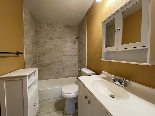 full bathroom featuring vanity, tiled shower / bath combo, and toilet