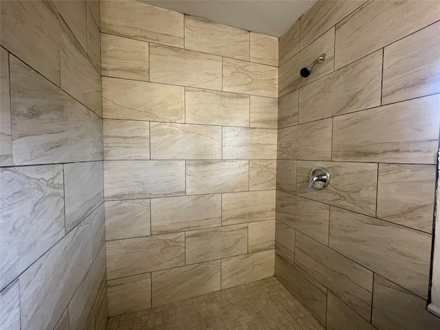 bathroom with a tile shower