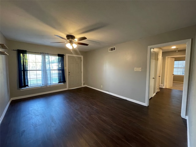 unfurnished room featuring dark hardwood / wood-style flooring, ceiling fan, and plenty of natural light