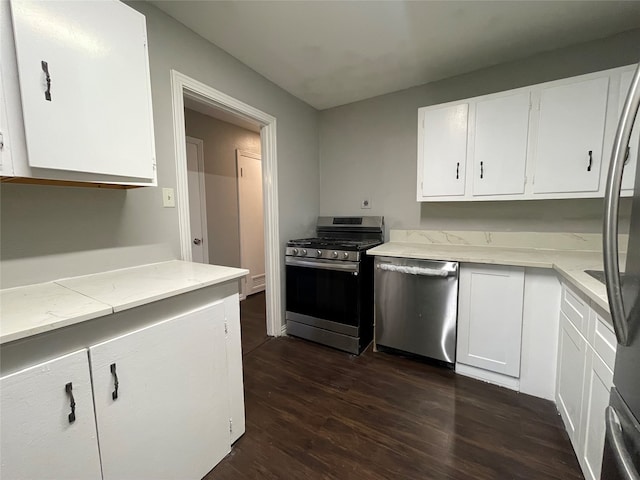 kitchen featuring dark wood-type flooring, white cabinetry, and stainless steel appliances