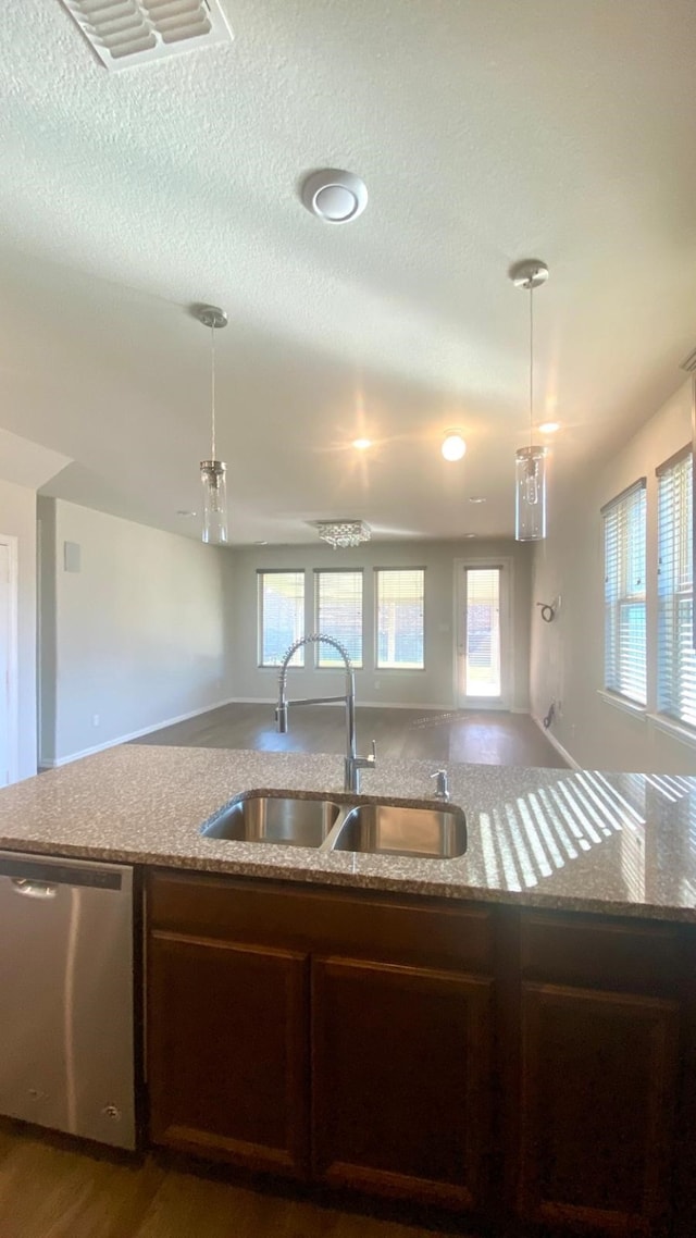 kitchen with stainless steel dishwasher, decorative light fixtures, a healthy amount of sunlight, and sink