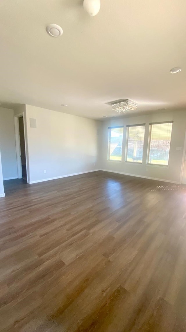 empty room featuring dark hardwood / wood-style flooring